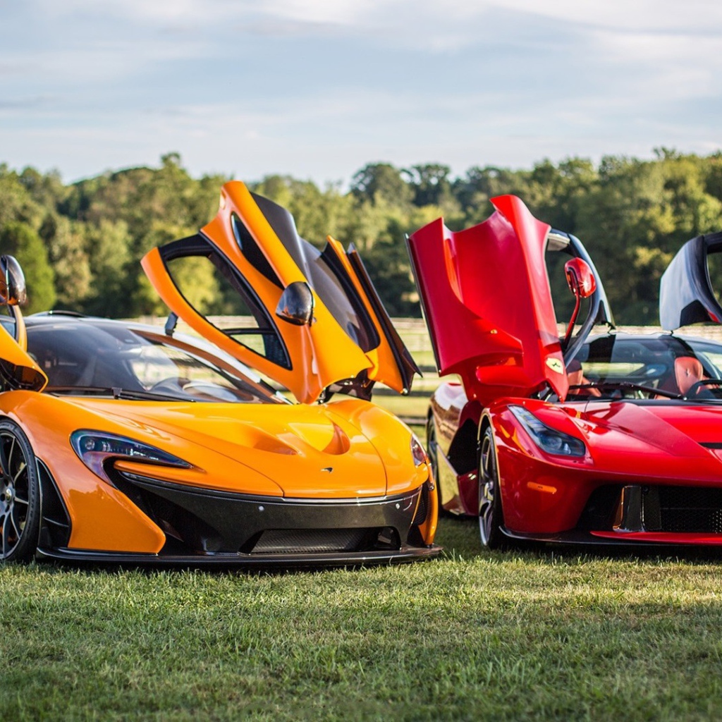 Красный Ferrari LaFerrari и оранжевый Макларен на газоне
