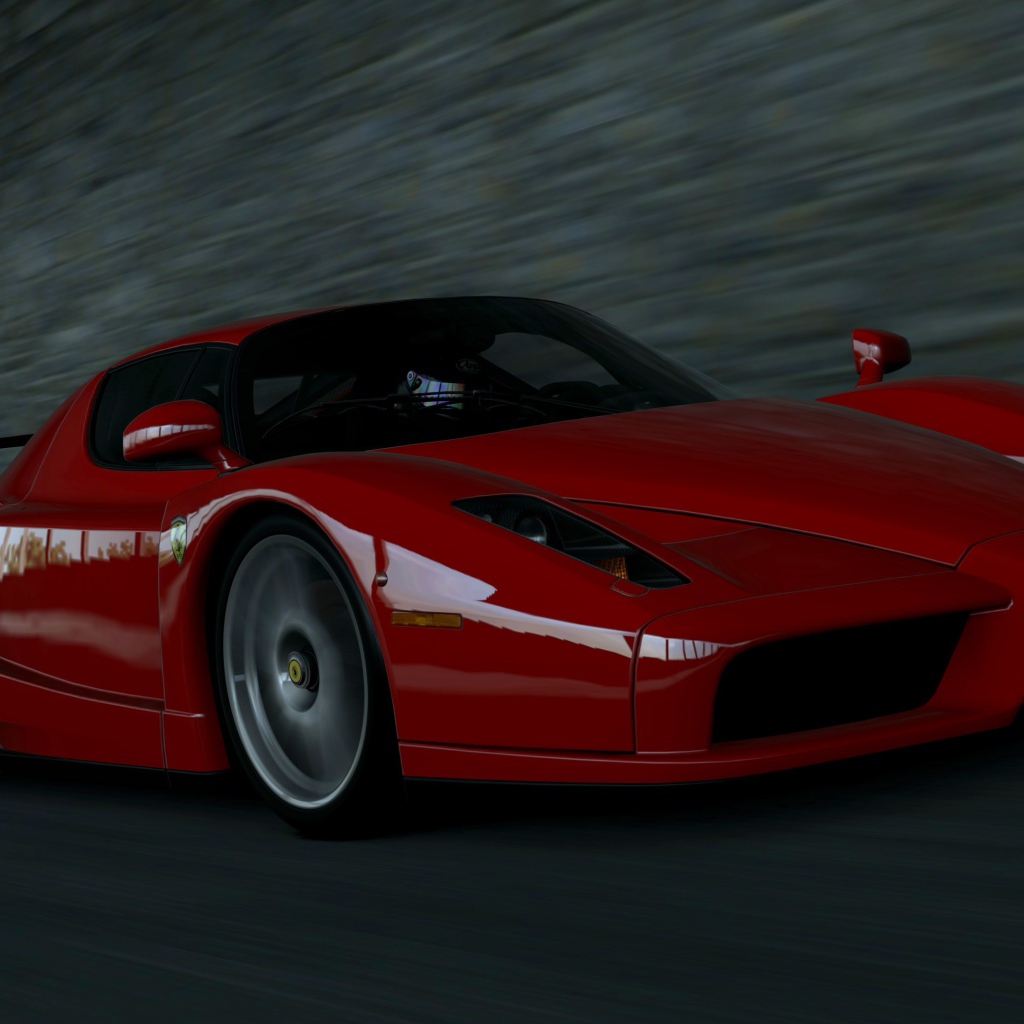 Красный Ferrari Enzo мчится на черном фоне