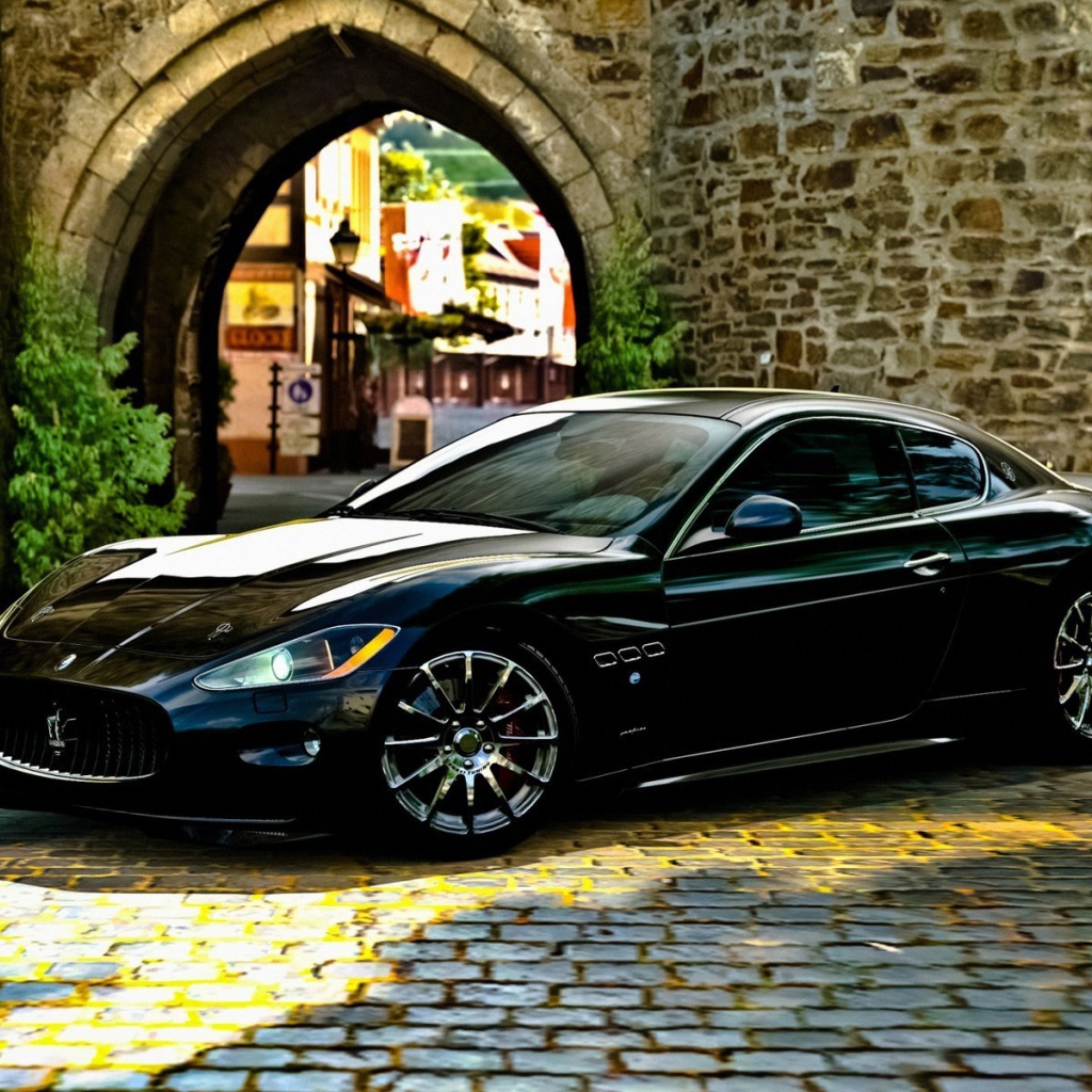 Черный Maserati gran turismo у каменной арки