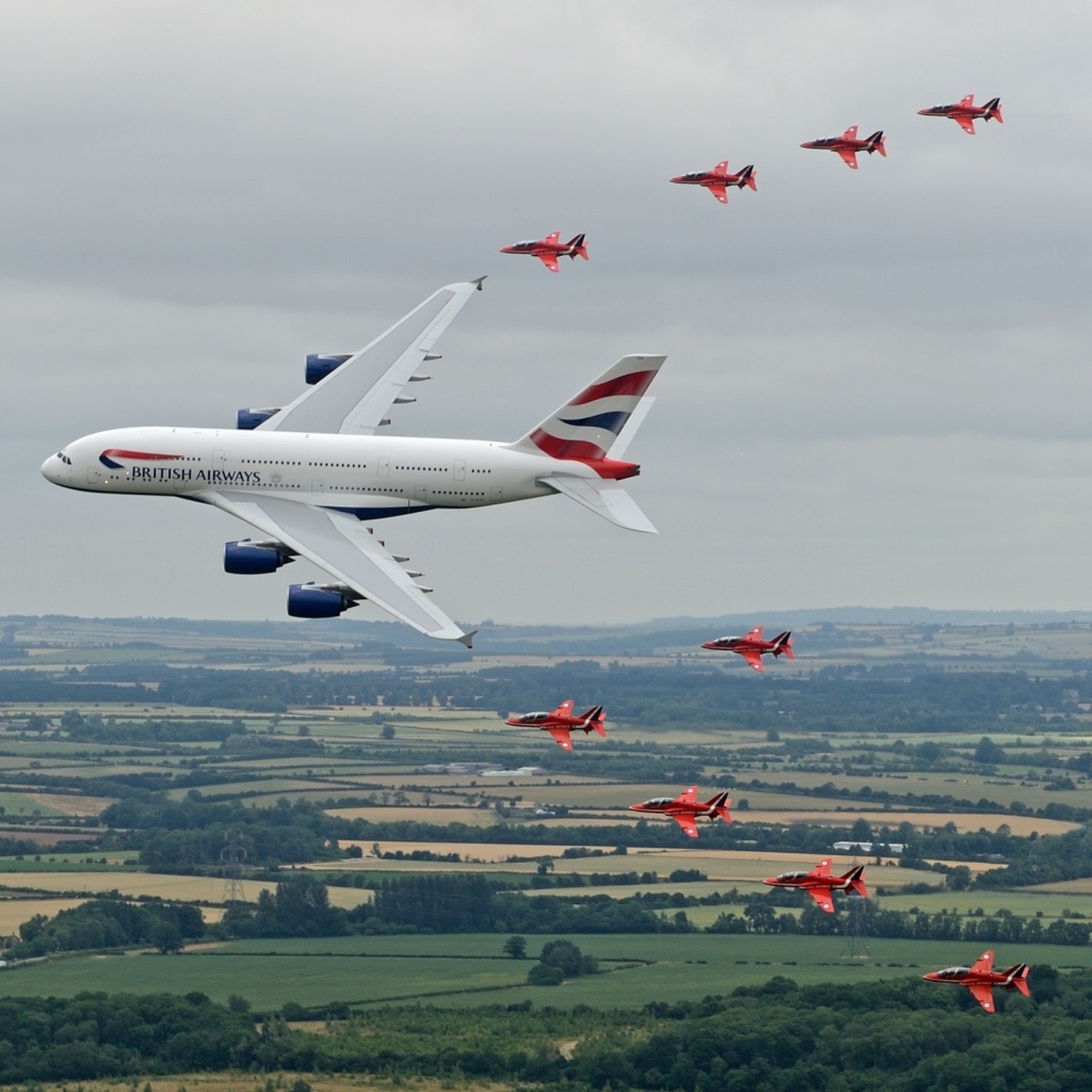 Airbus A380 в сопровождении красных истребителей