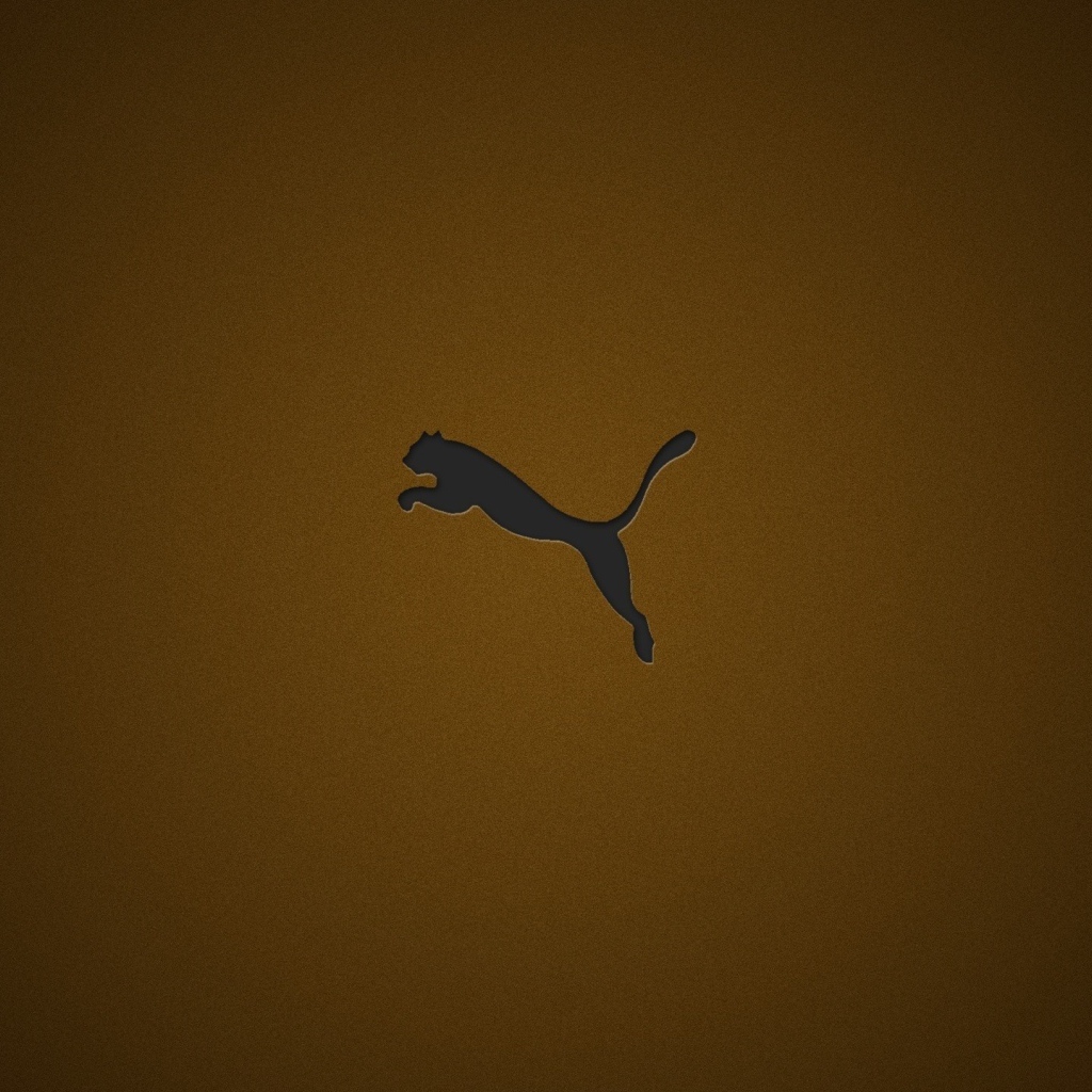 Логотип фирмы Пума на коричневом фоне