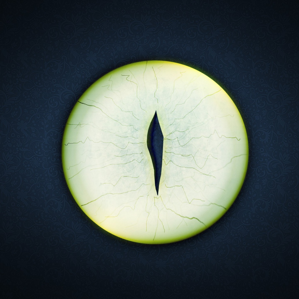 Круглый зеленый глаз на черном фоне