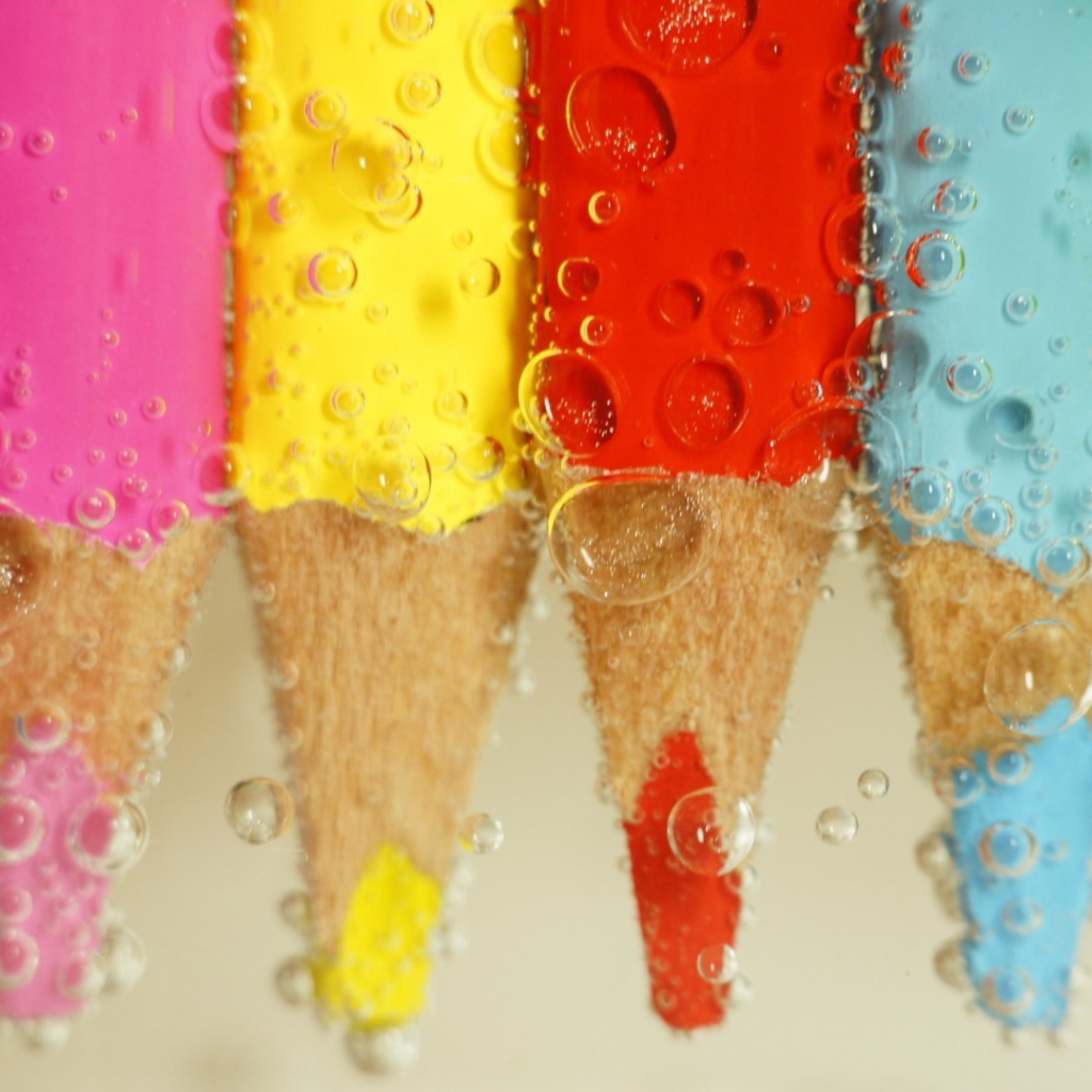 Карандаши в воде среди пузырей воздуха