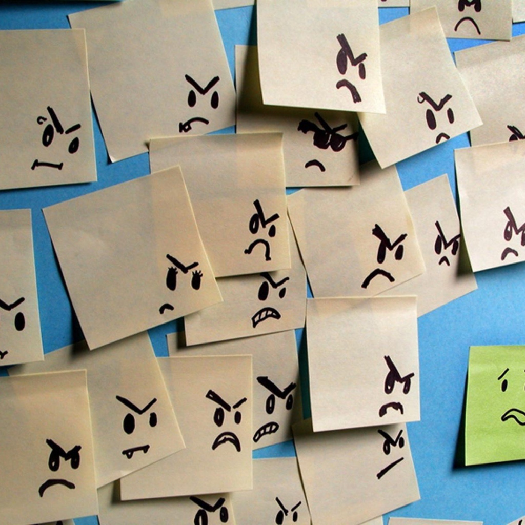 Испуганный стикер в окружении злых стикеров