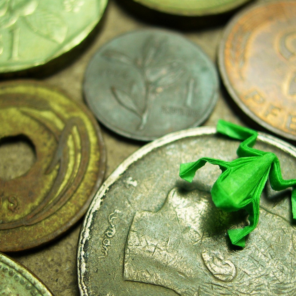 Frog figurine on coins