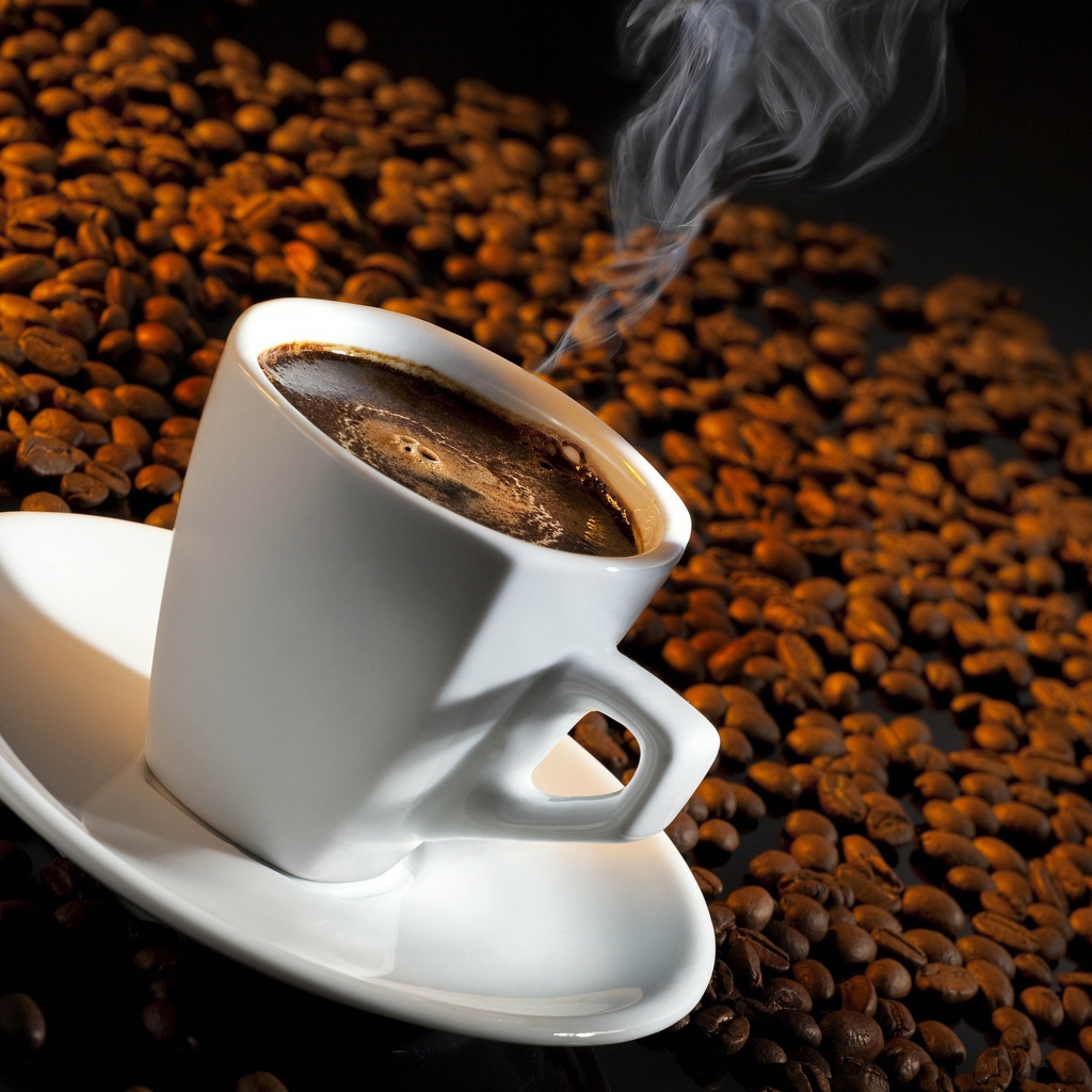 Белая чашка с кофе на зернах