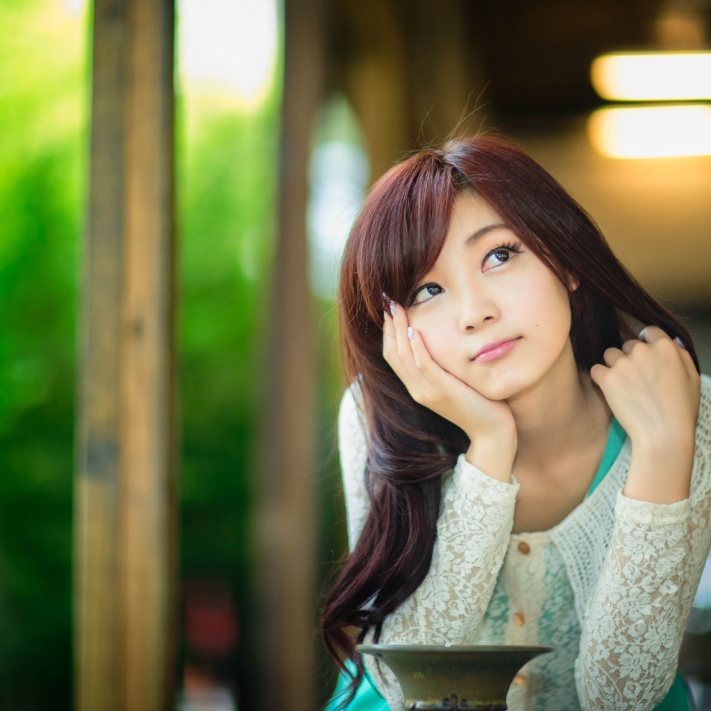Asian girl thoughtfully looking up