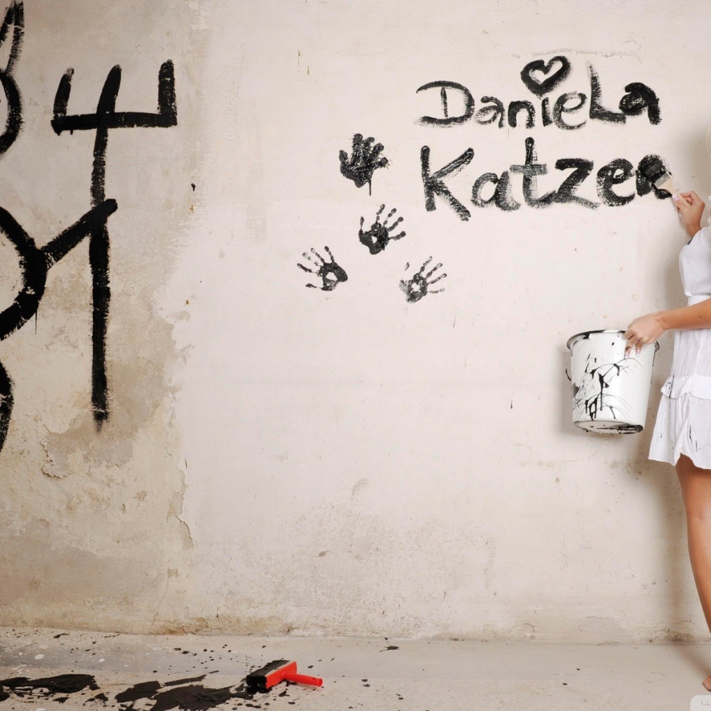 Блондинка рисует на стене