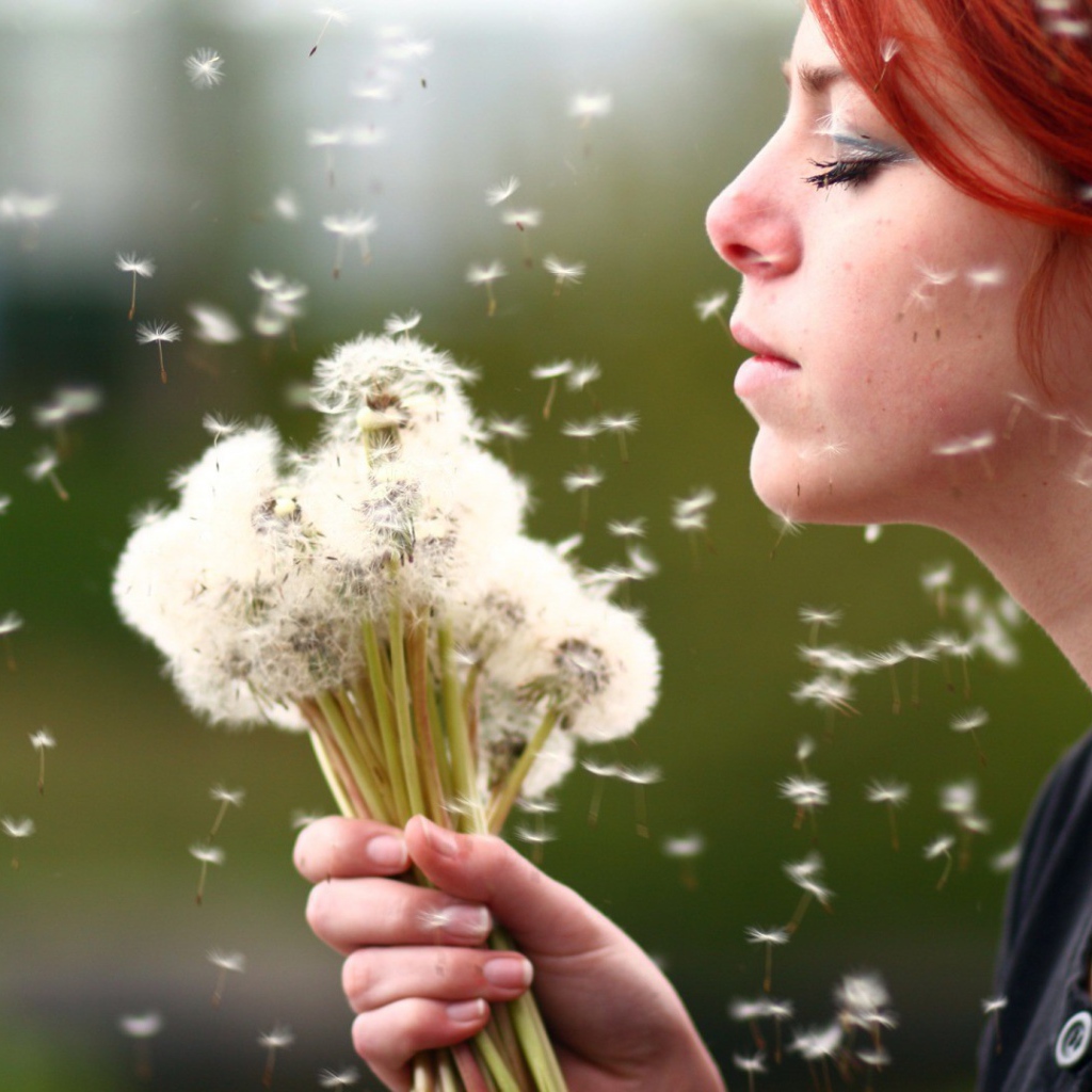 Девушка держит в руках букет одуванчиков
