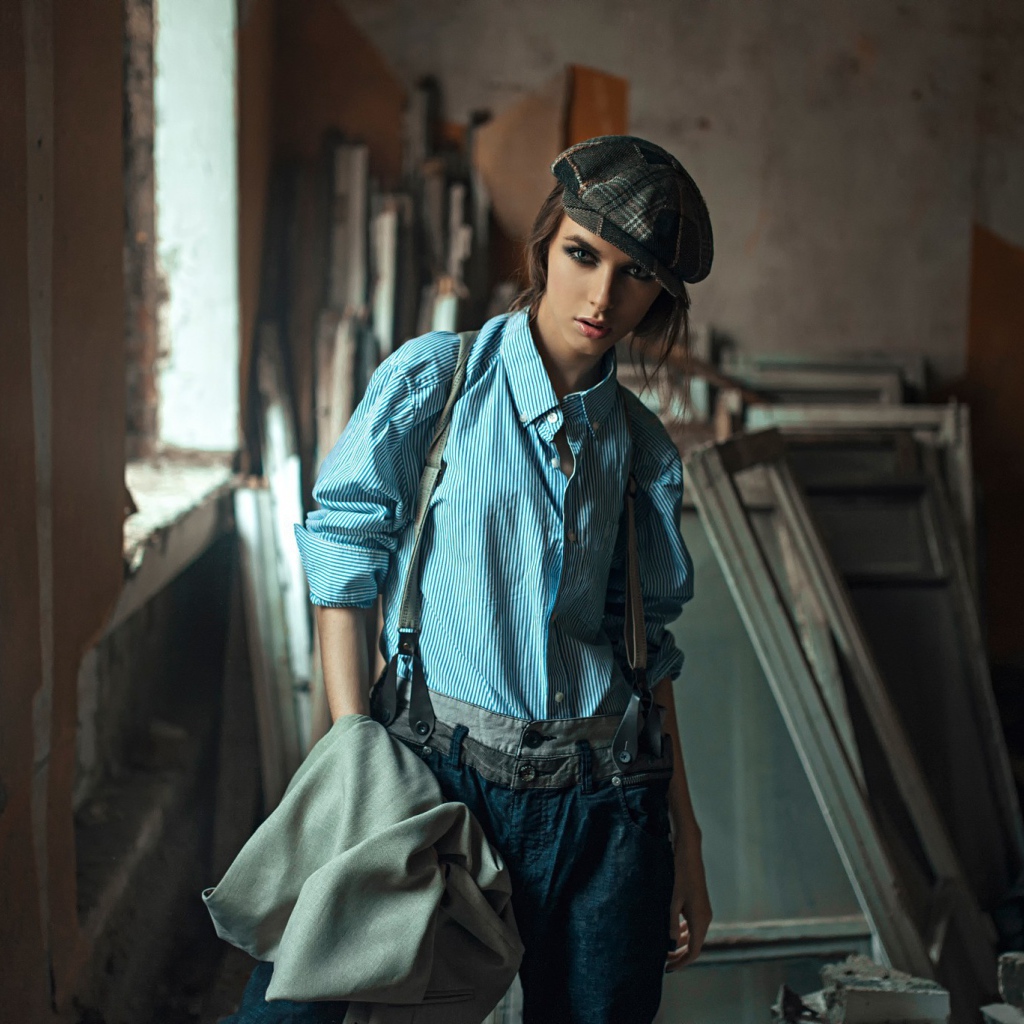 Девушка в берете стоит среди ремонта