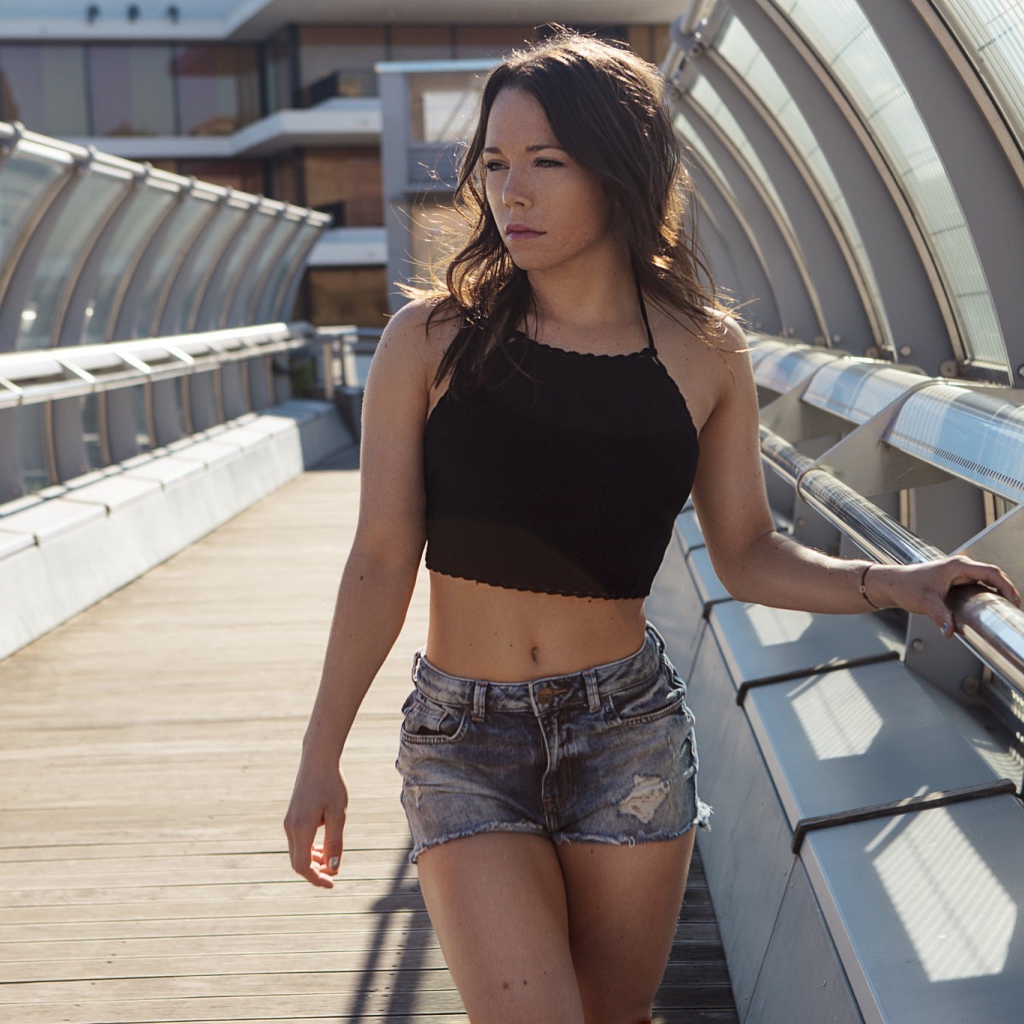 Girl in denim shorts on the bridge
