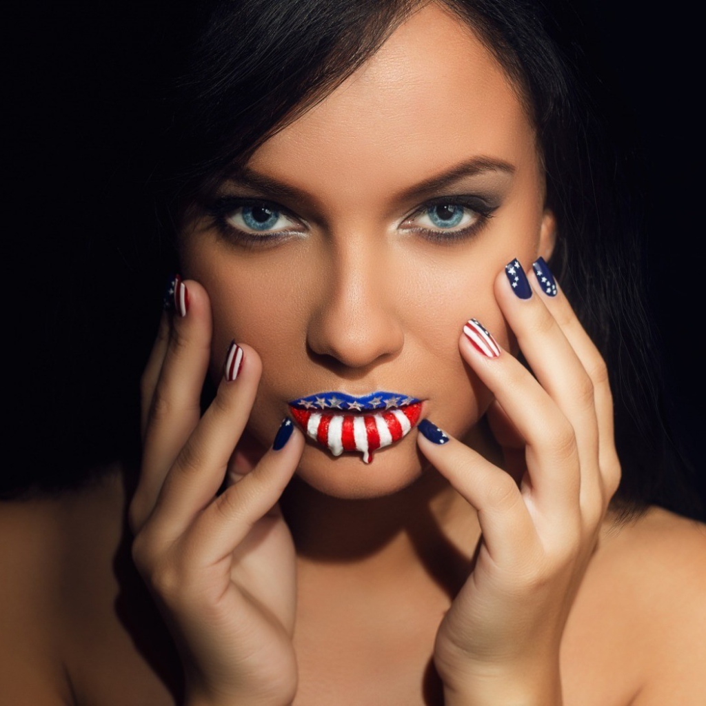 Lips and nails of the girl painted in colors of the flag