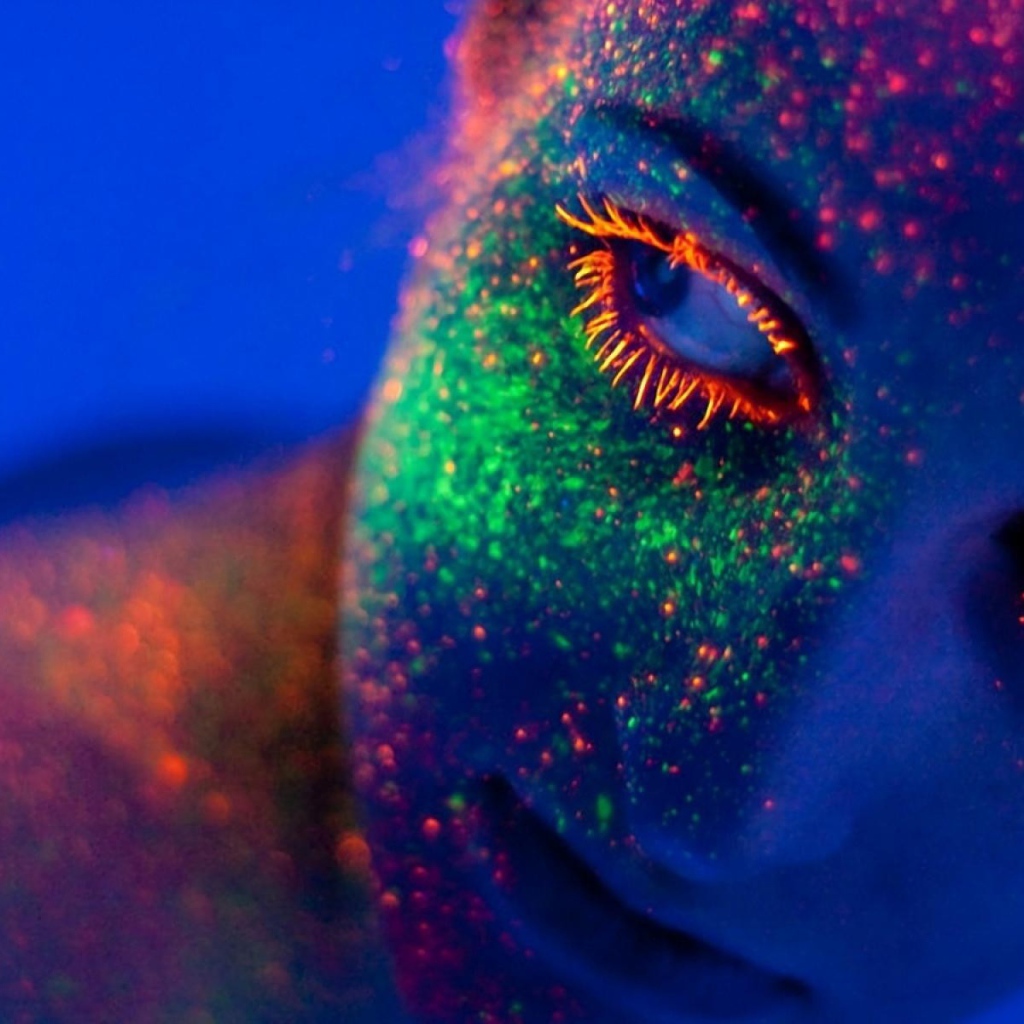 Неоновая краска на лице у девушки