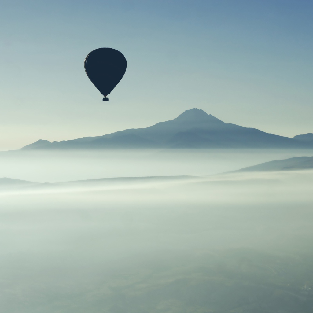 Черные воздушные шары над туманом