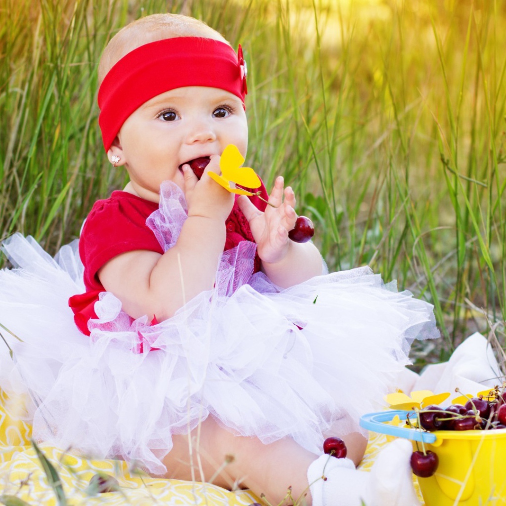 Девочка кушает спелые вишни