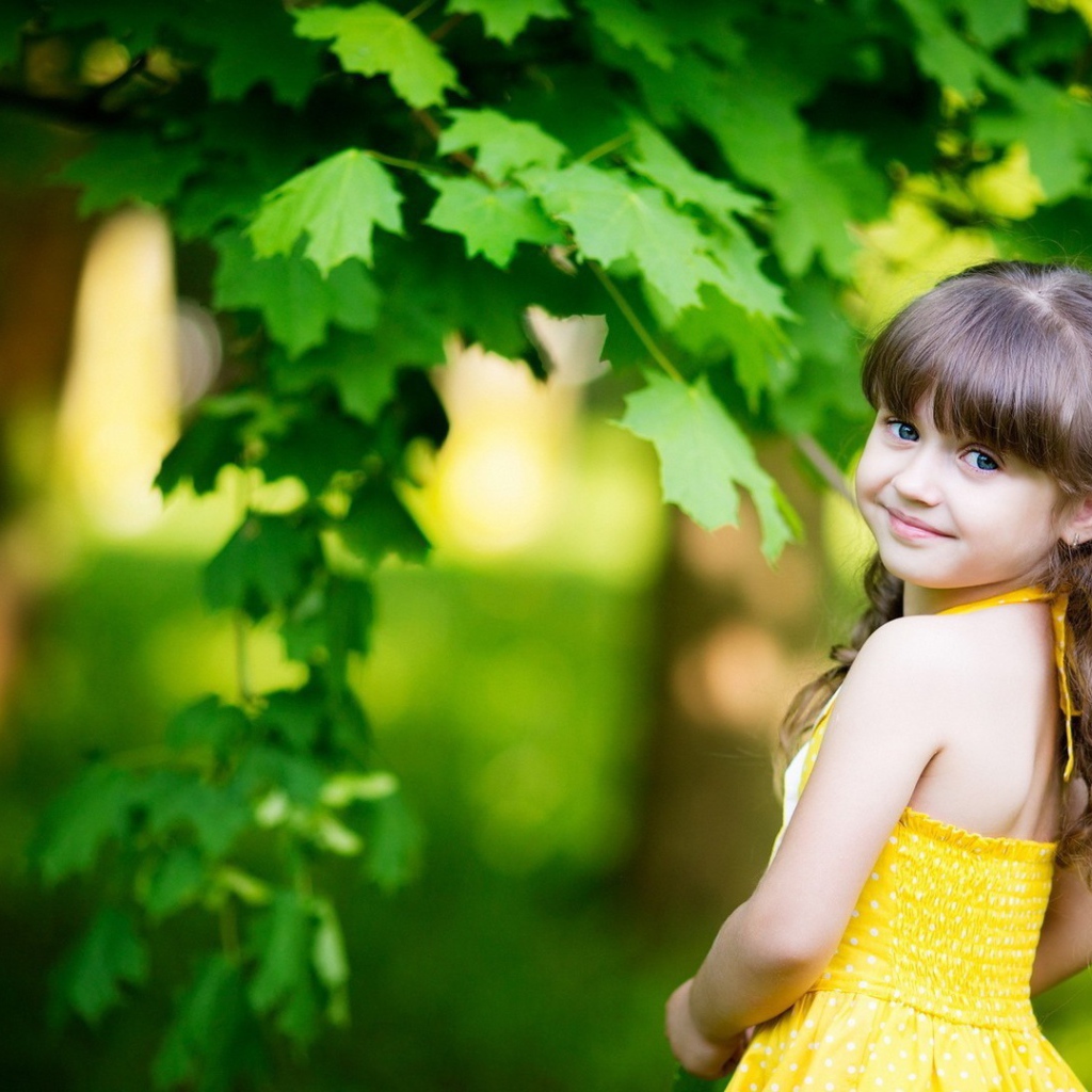 Маленькая девочка у зеленого клена