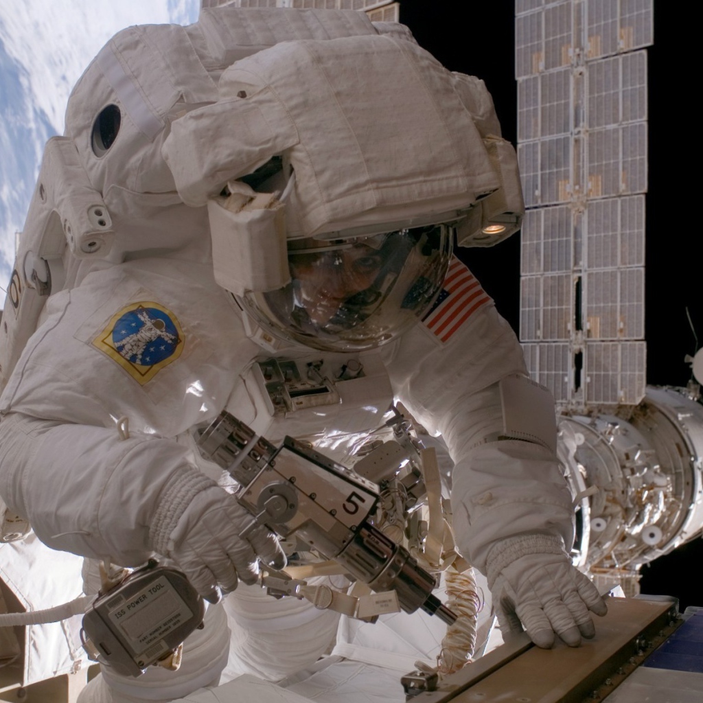 Космонавт на орбите выполняет ремонт