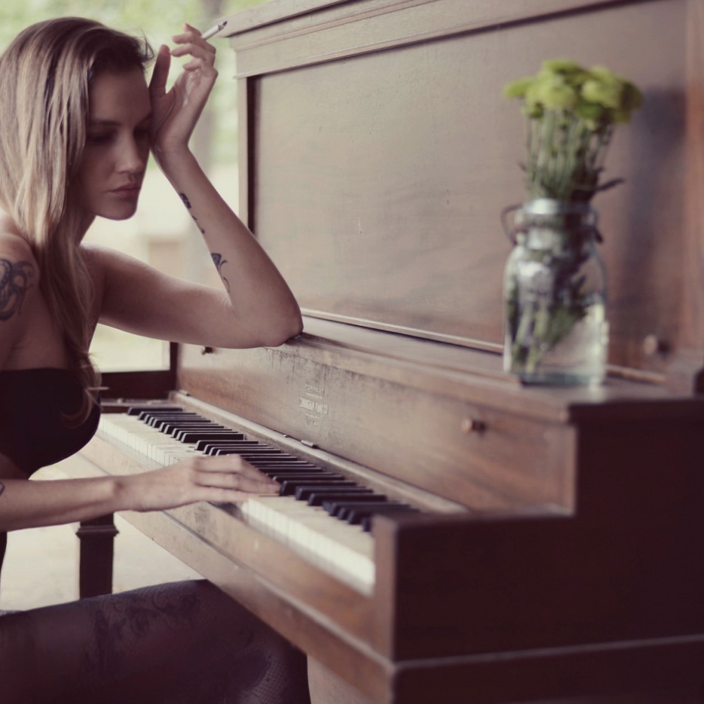 Girl with tattoo playing the piano
