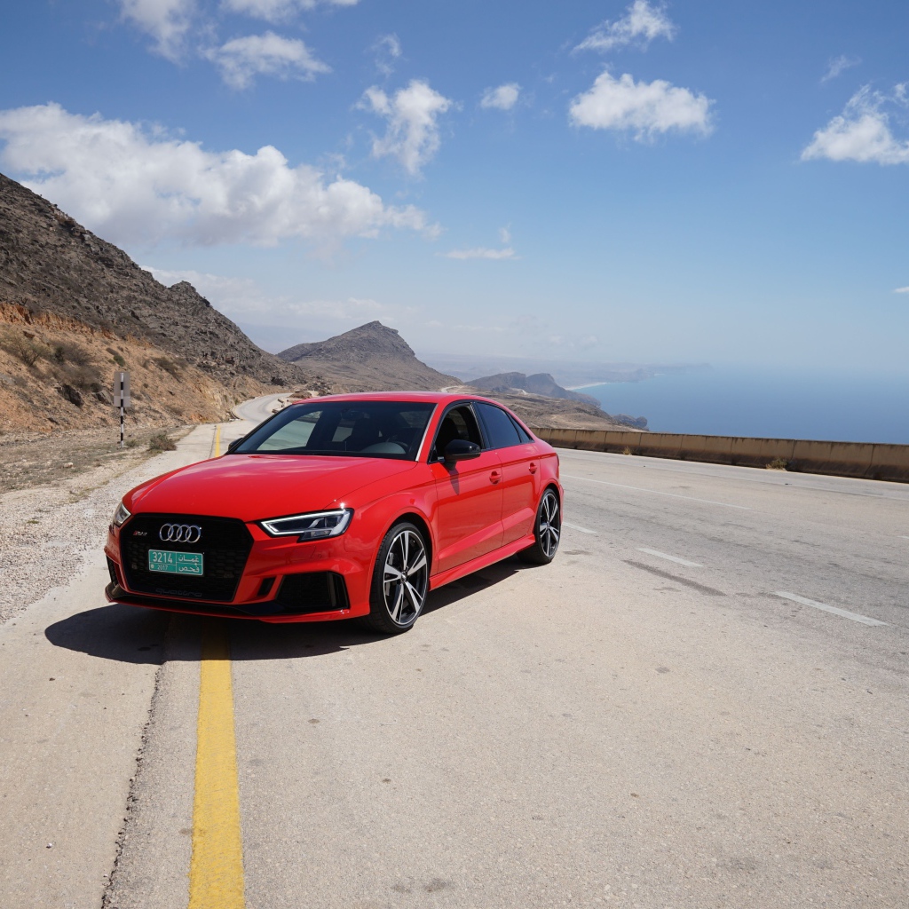 Red car Audi RS 3 on the track against the blue sky
