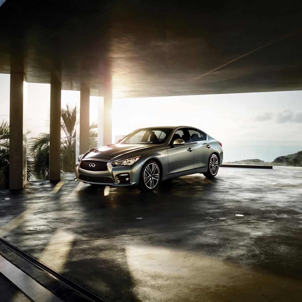 Серебристый автомобиль Infiniti Q50 в лучах солнца 