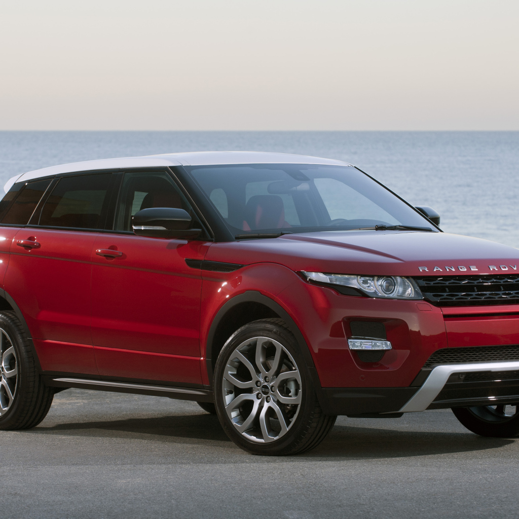 Красный автомобиль Land Rover Caractere на фоне океана