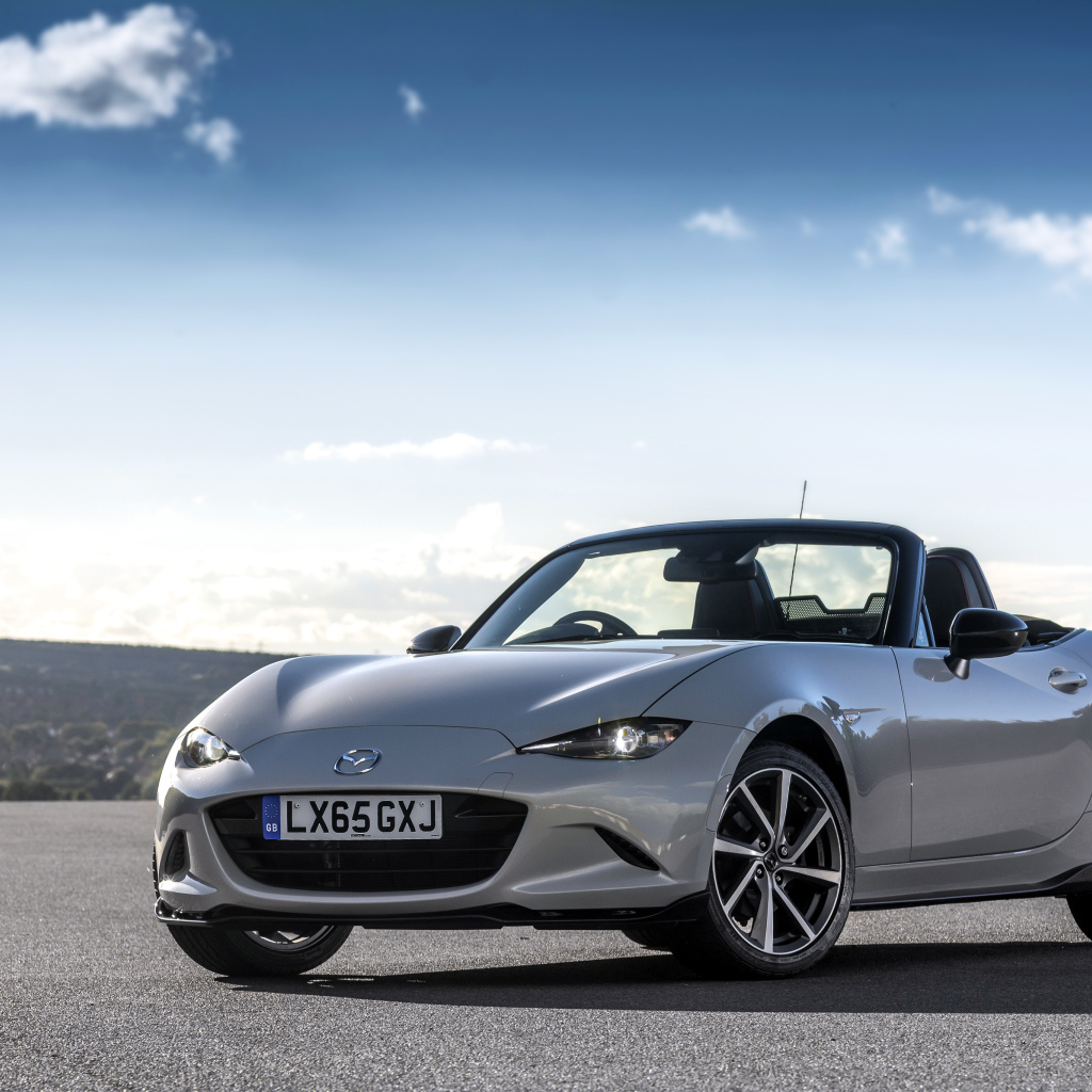 Mazda MX-5 silver cabriolet on the background of a beautiful sky