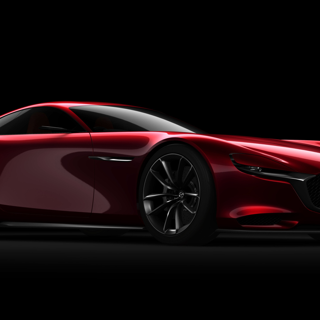 Красный спортивный автомобиль Mazda RX Vision Concept на черном фоне