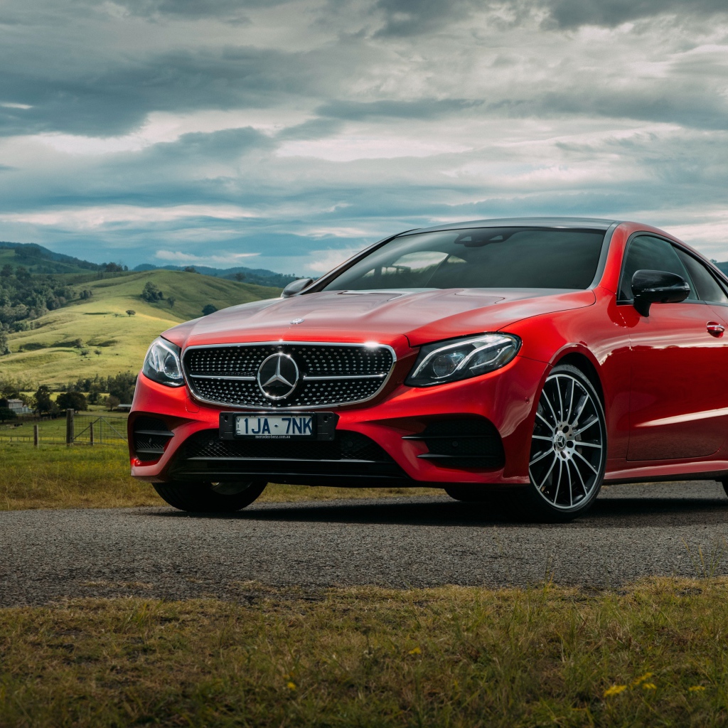 Красный автомобиль Mercedes-Benz E-Class на фоне природы