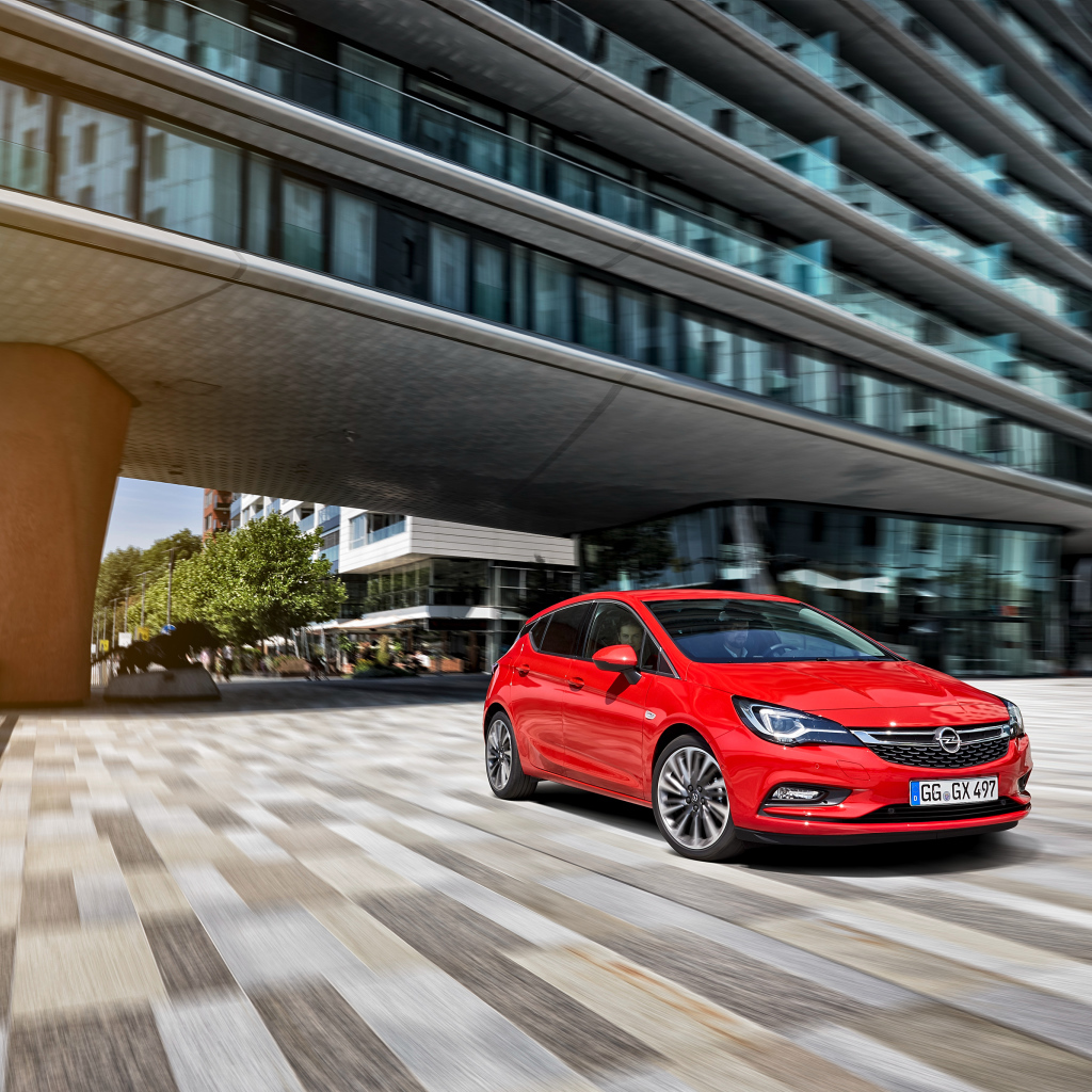 Красный автомобиль Opel Astra в движении