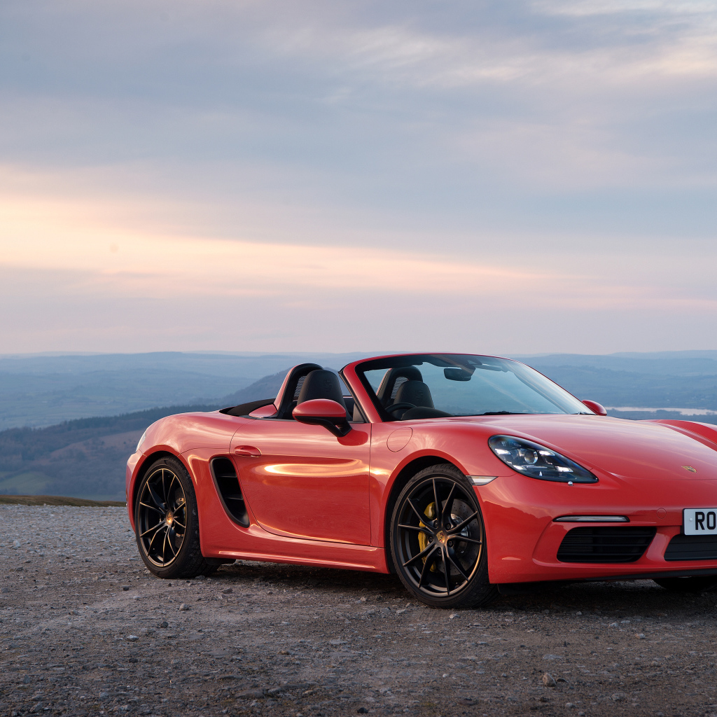 Red Car Convertible Porsche 718 Boxster on the background of the horizon
