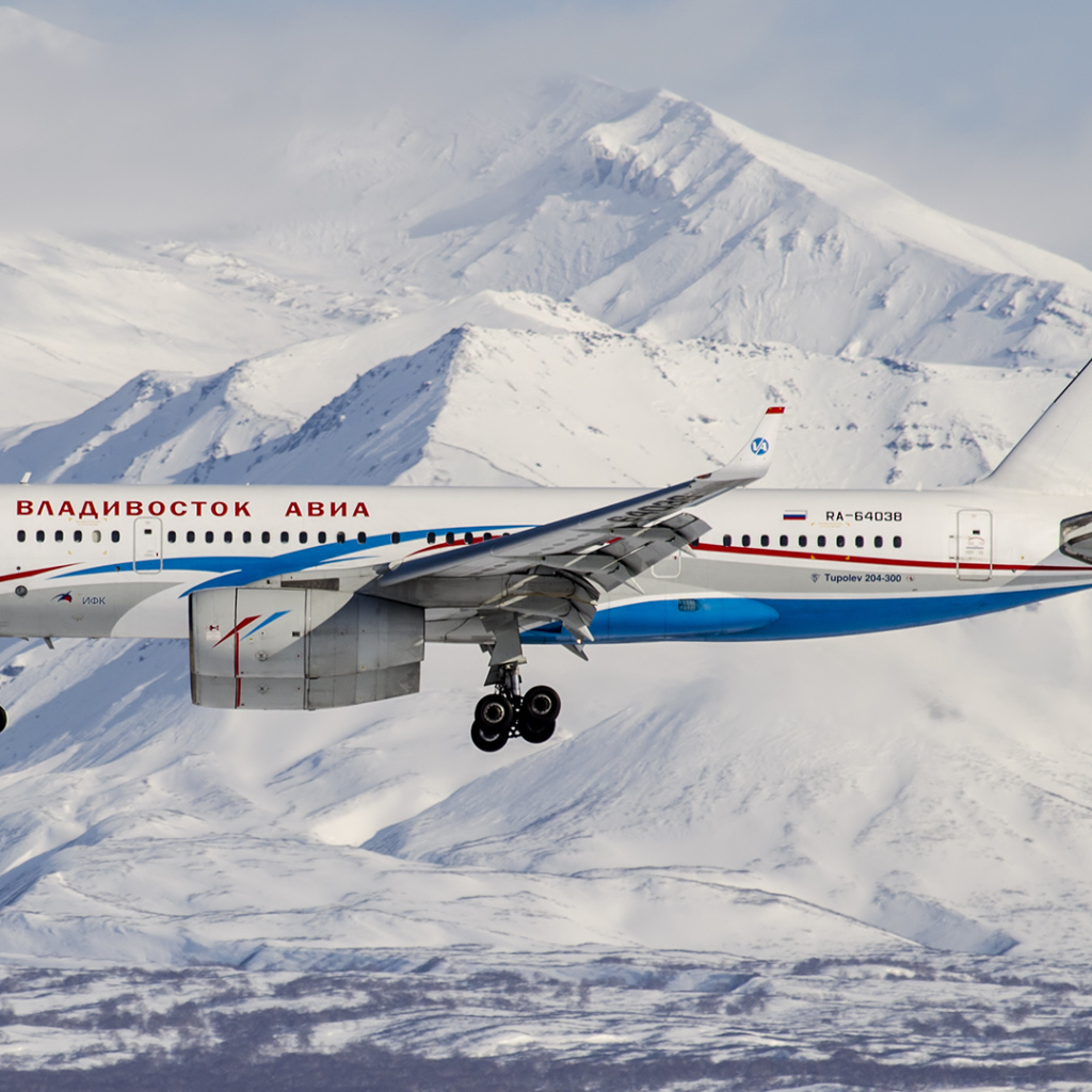TU 204-300 airline Vladivostok Air flies over the mountains of Altai
