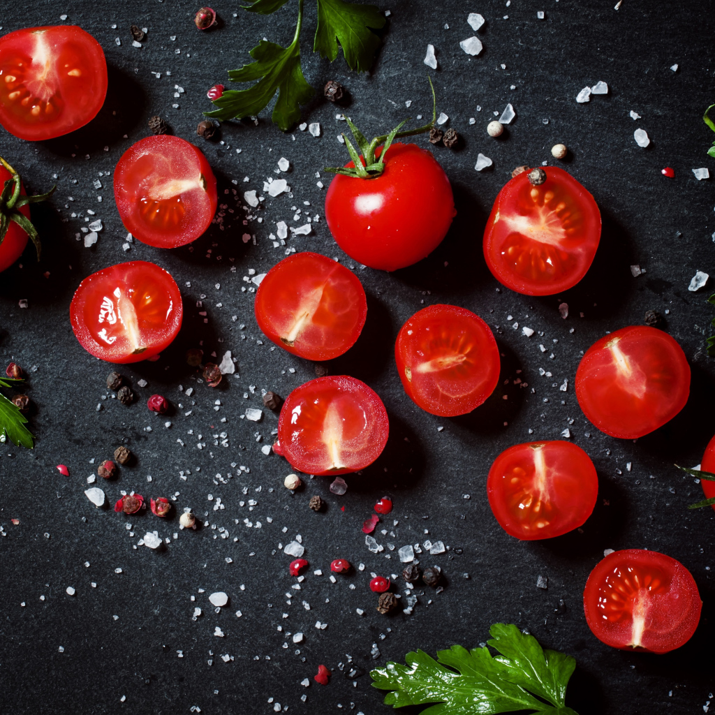 Tomatoes on the table with parsley and spices