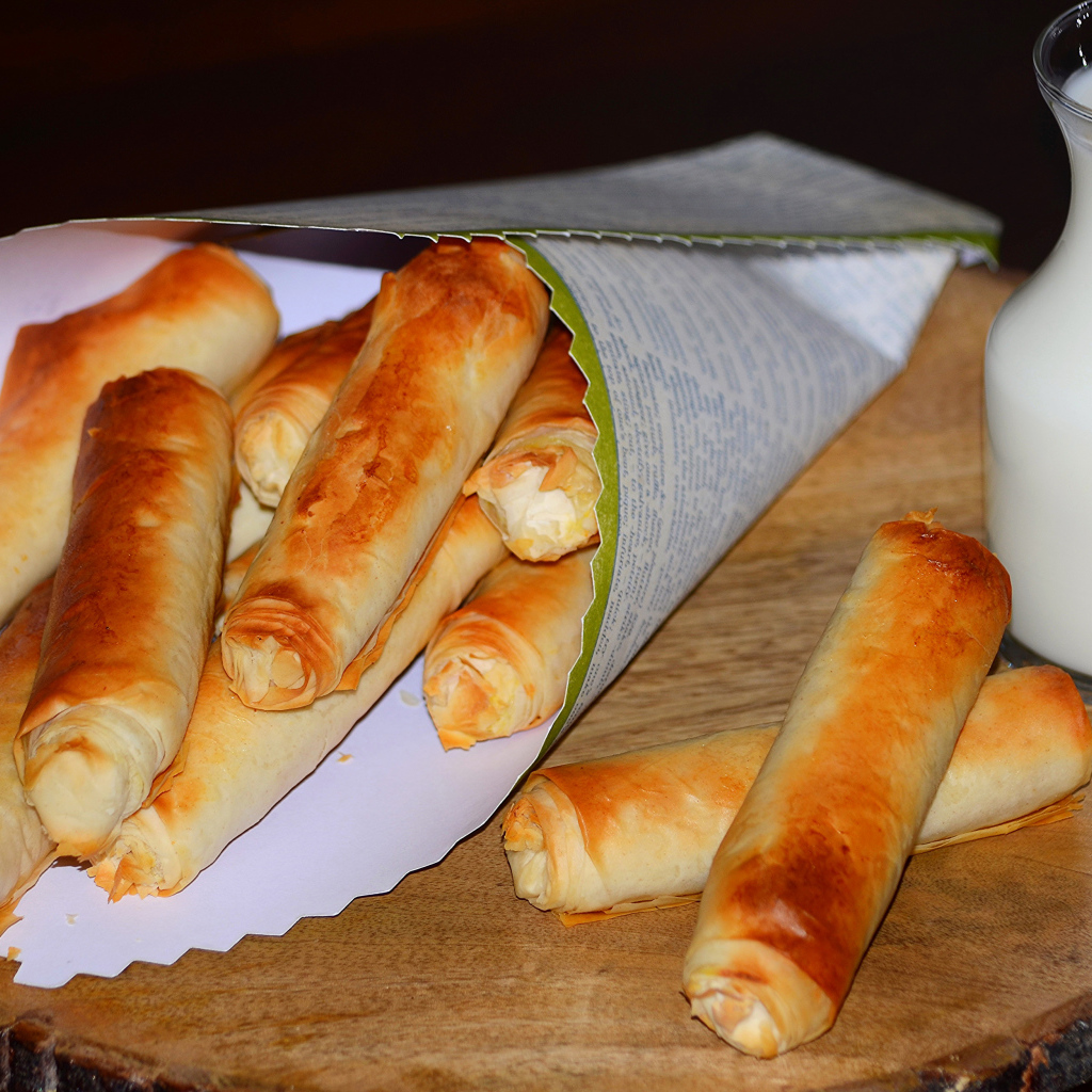 Сладкая выпечка с творогом на столе с кувшином молока