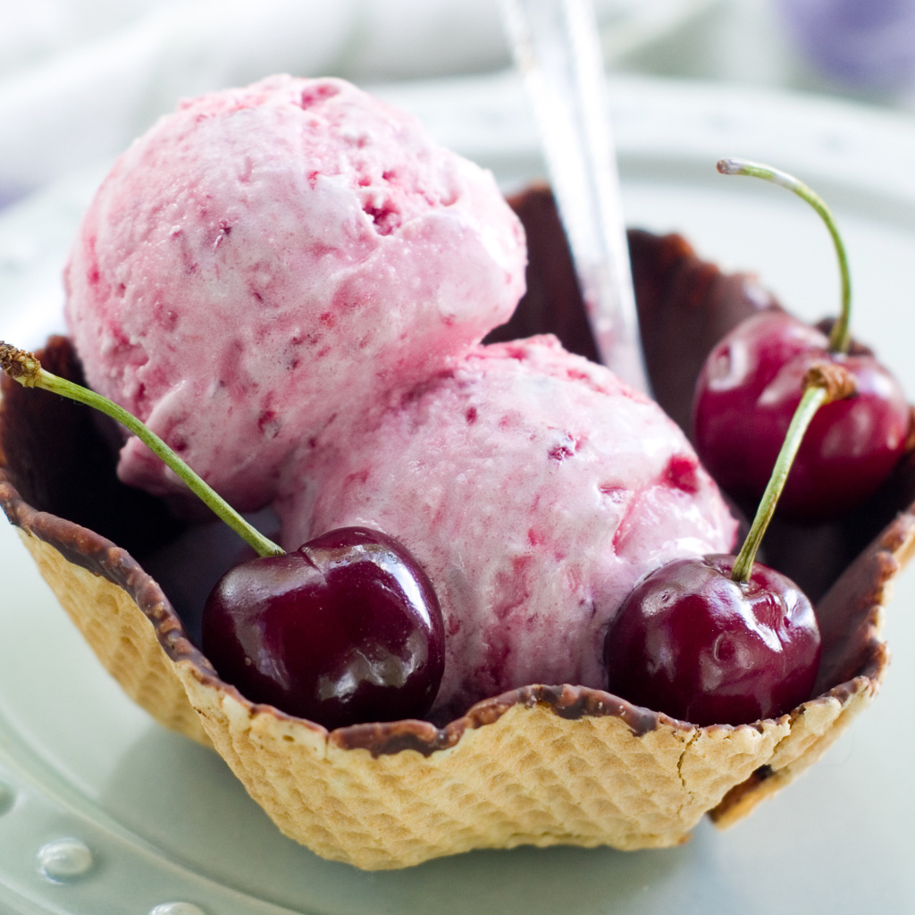 Два шарика вишневого мороженого в вафельной корзинке