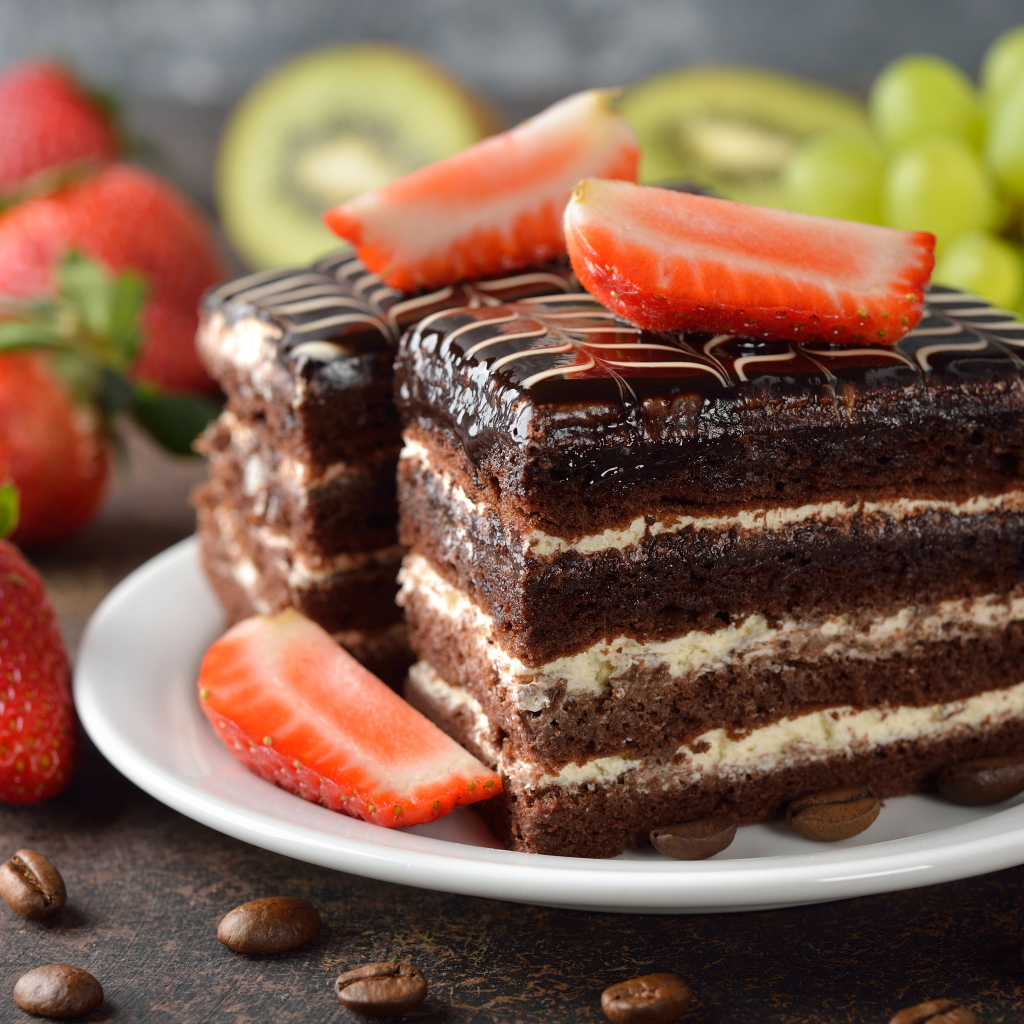 Два кусочка шоколадного пирожного с ягодами клубники