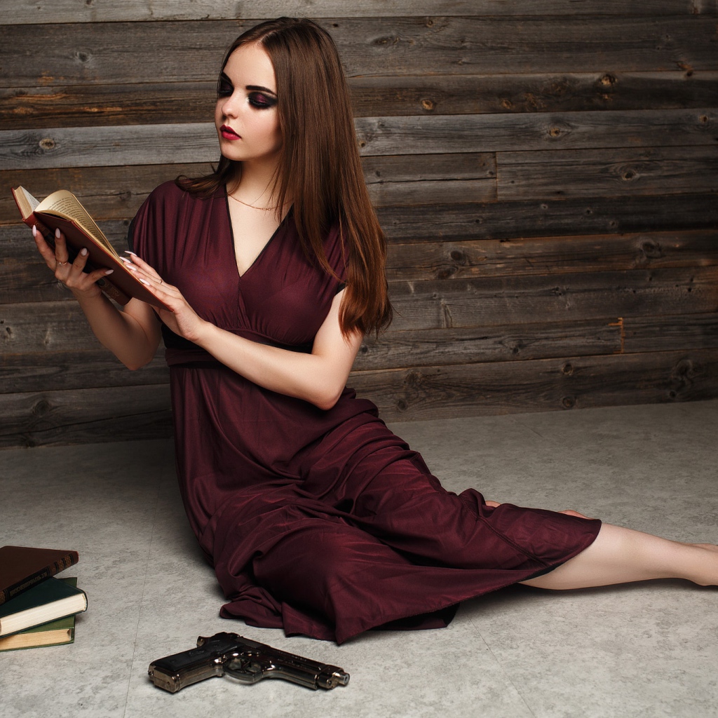 Красивая девушка в бордовом платье с книгами