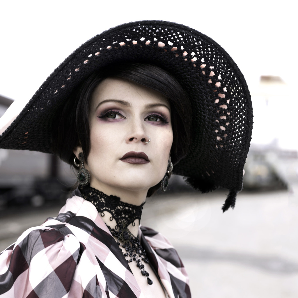 Красивая зеленоглазая девушка в большой черной шляпе