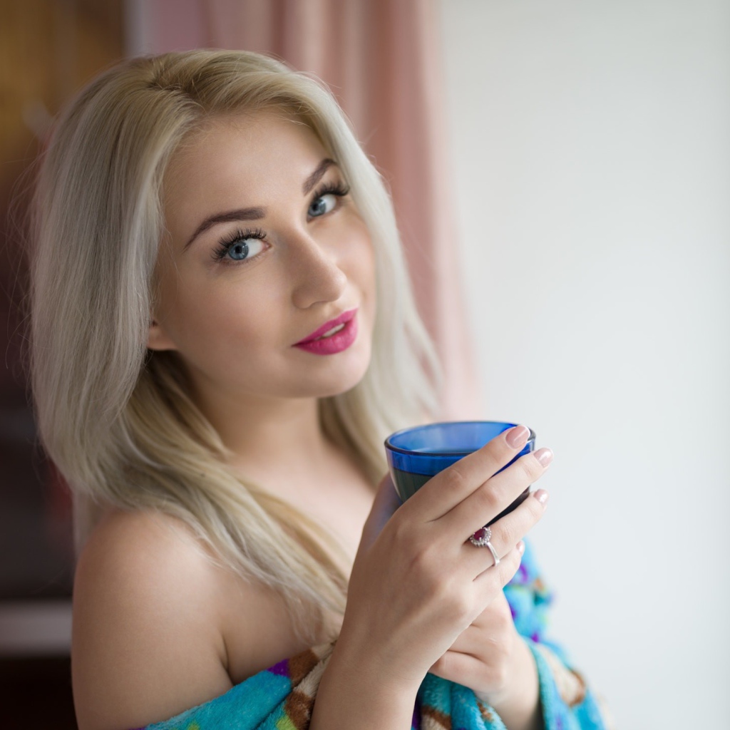 Блондинка с розовыми губами и стаканом в руках 