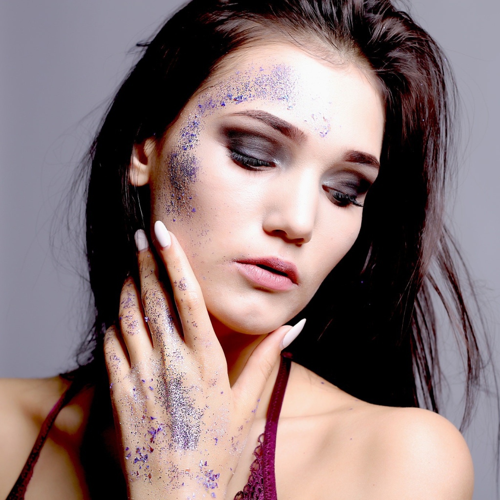 Брюнетка с блестками на лице 
