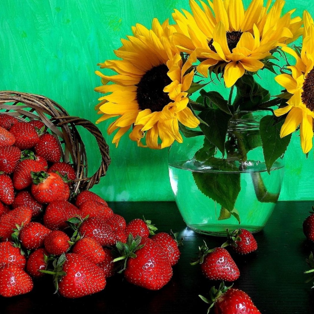 Цветы желтого подсолнуха в вазе со свежей клубникой 
