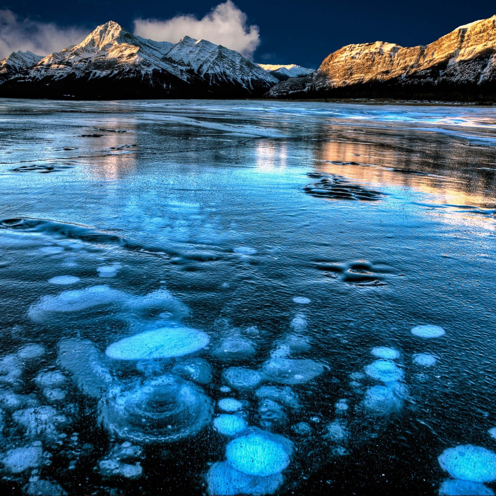 Ice-covered clear Lake Abraham amid mountains, Canada