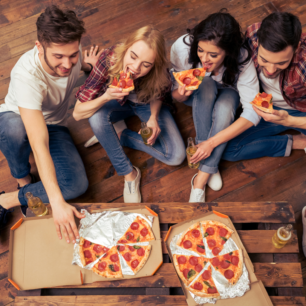 A company of friends eating an appetizing pizza