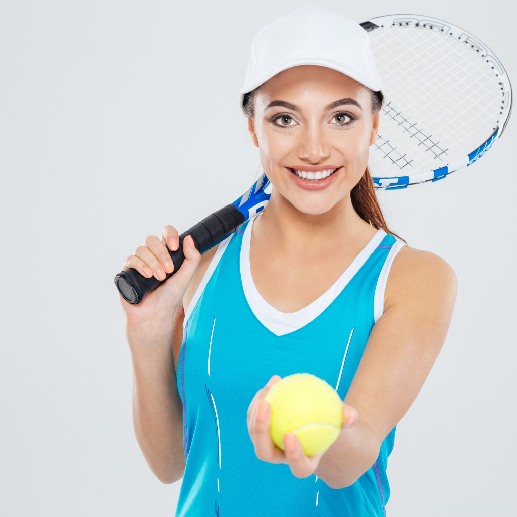 Girl sportswoman with tennis racket and ball