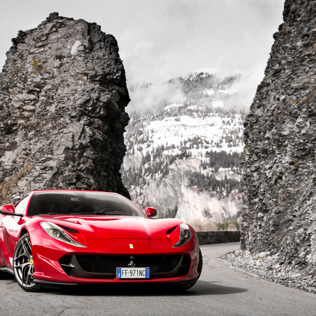 Красный спортивный автомобиль Ferrari Portofino 2018 года на фоне гор