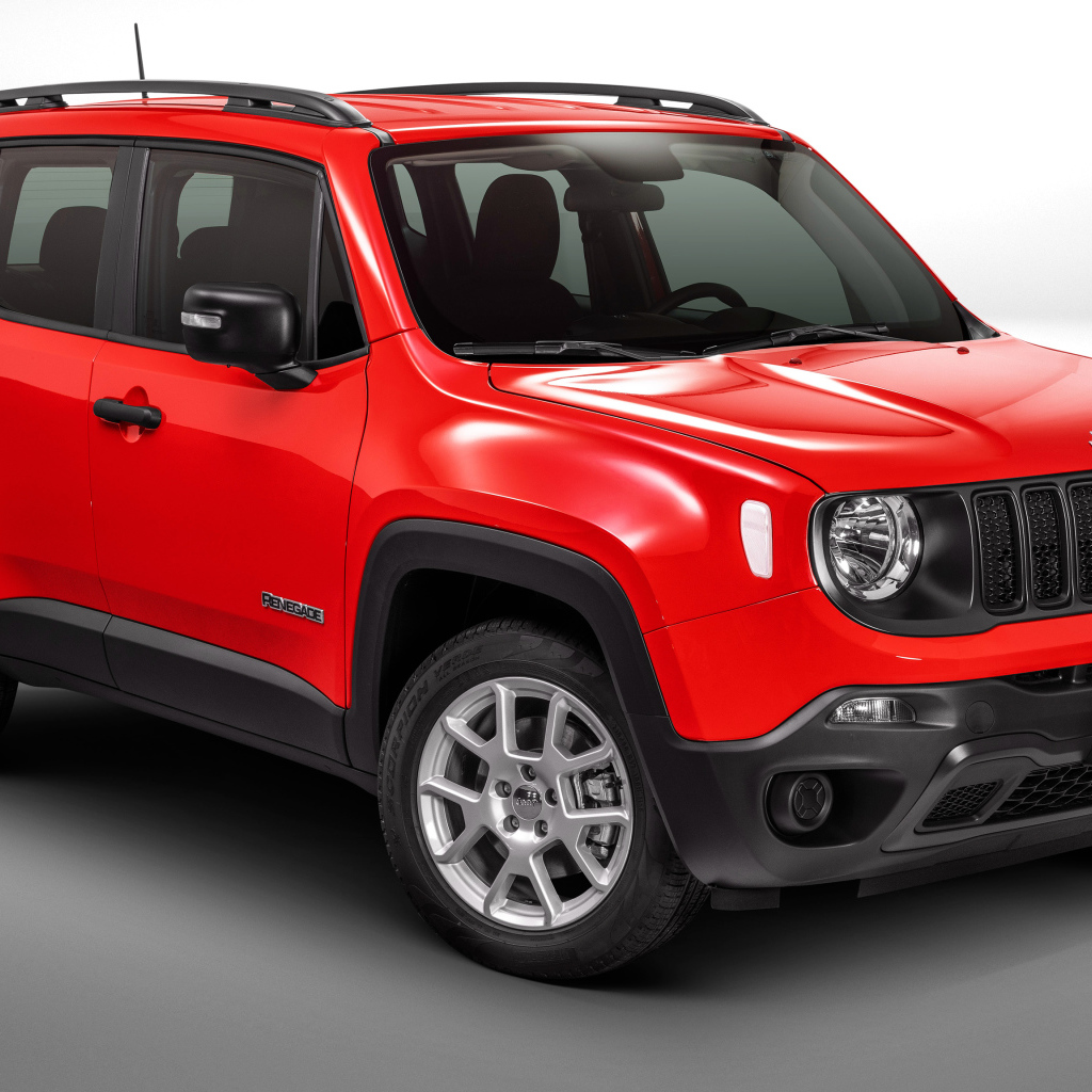 Красный автомобиль Jeep Renegade Sport на сером фоне