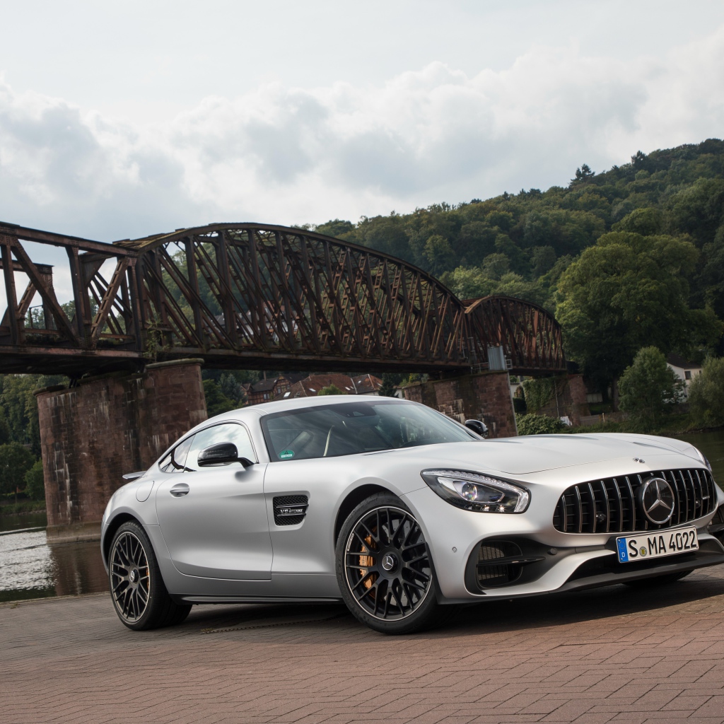 Silver car Mercedes-AMG GT on the background of the bridge