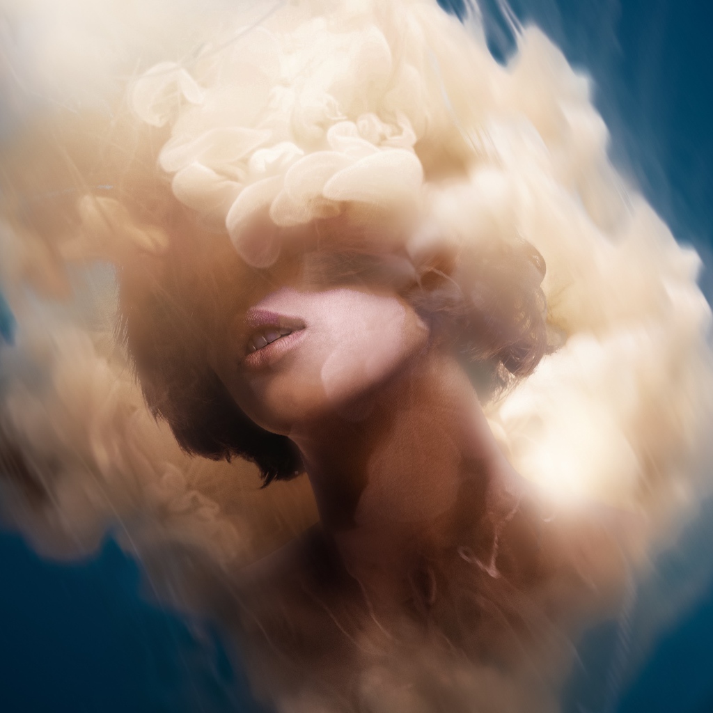 The girl's face in the smoke on a blue background, illusion
