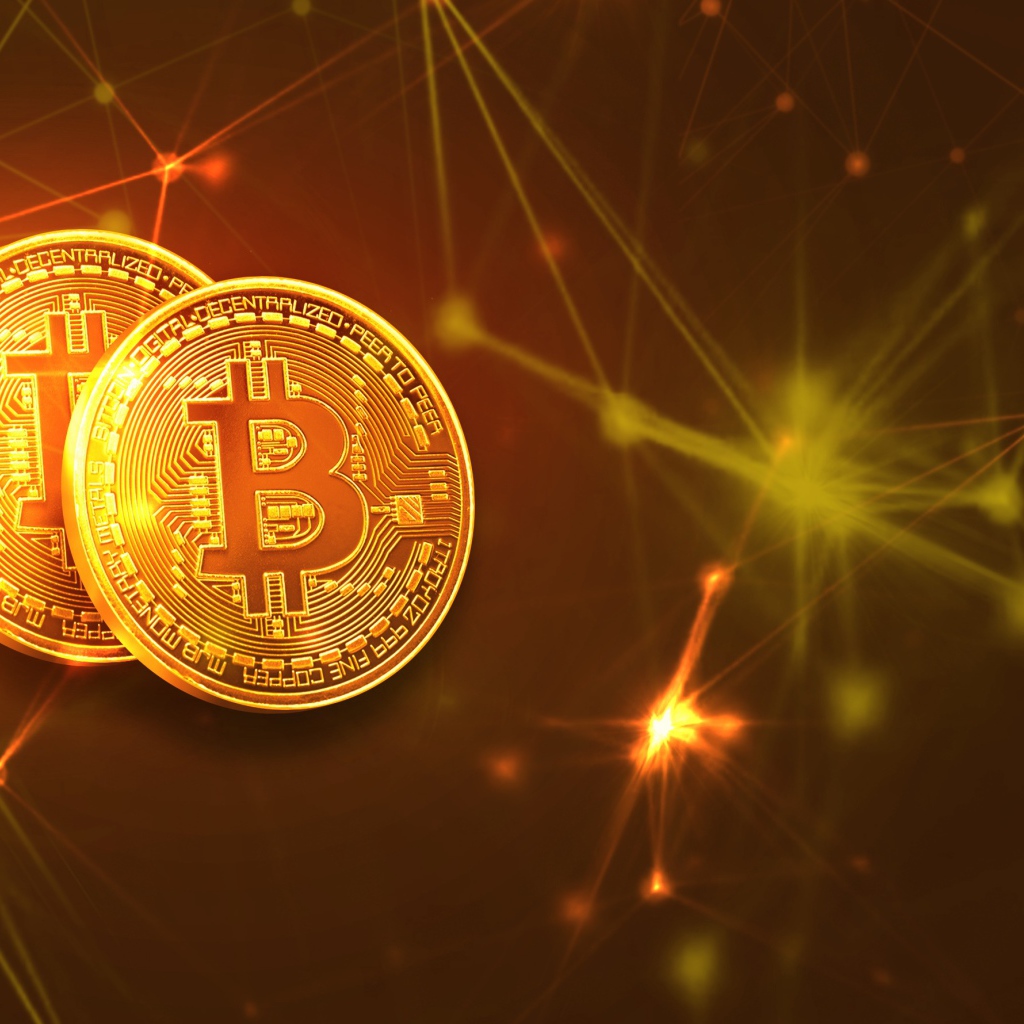 Two gold coins bitcoin against a background of virtual rays