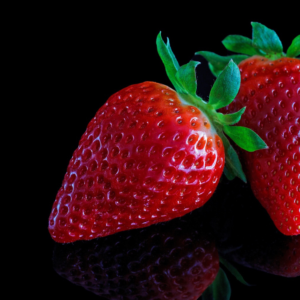 Красивая крупная красная клубника на черном  фоне