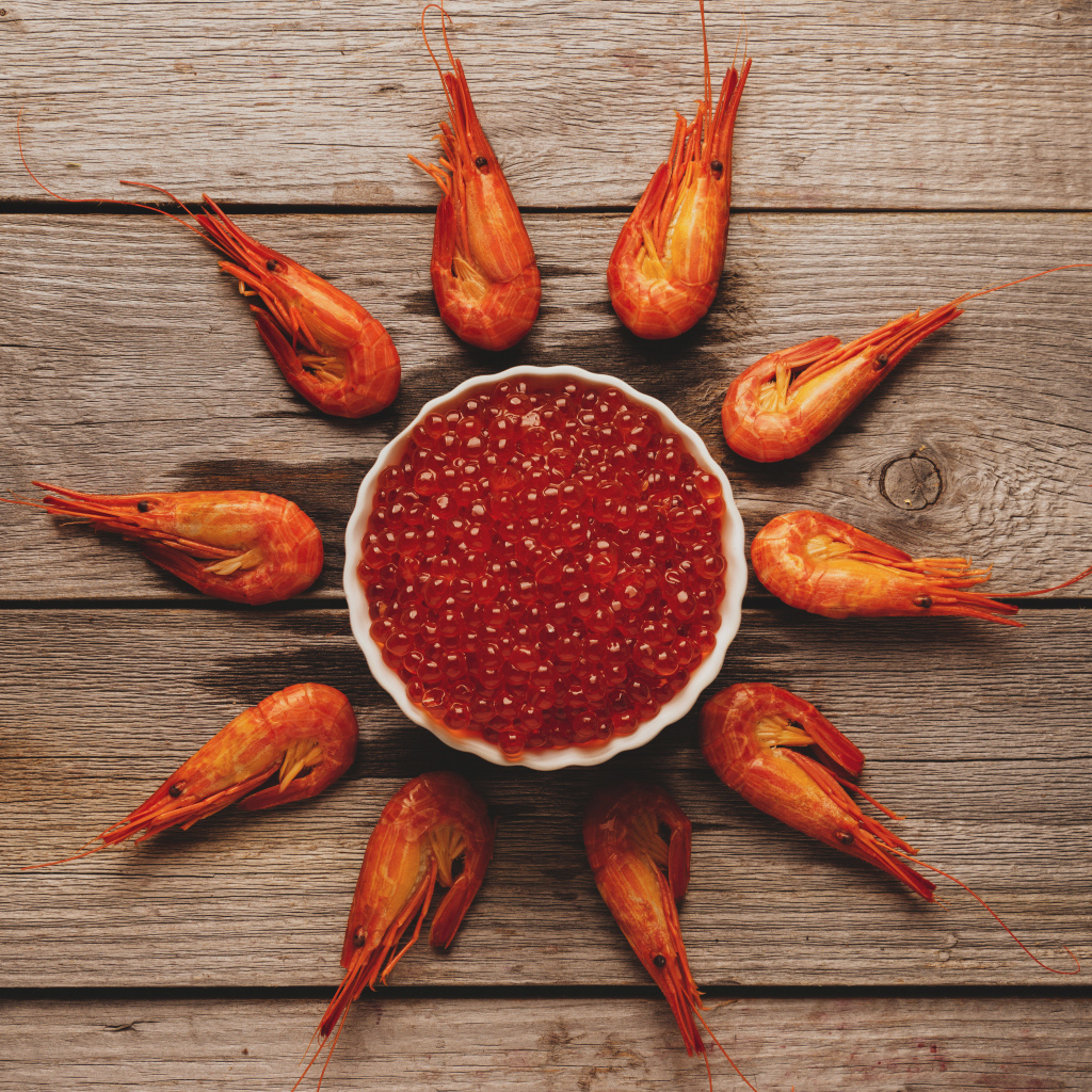 Boiled shrimps on the table with red caviar